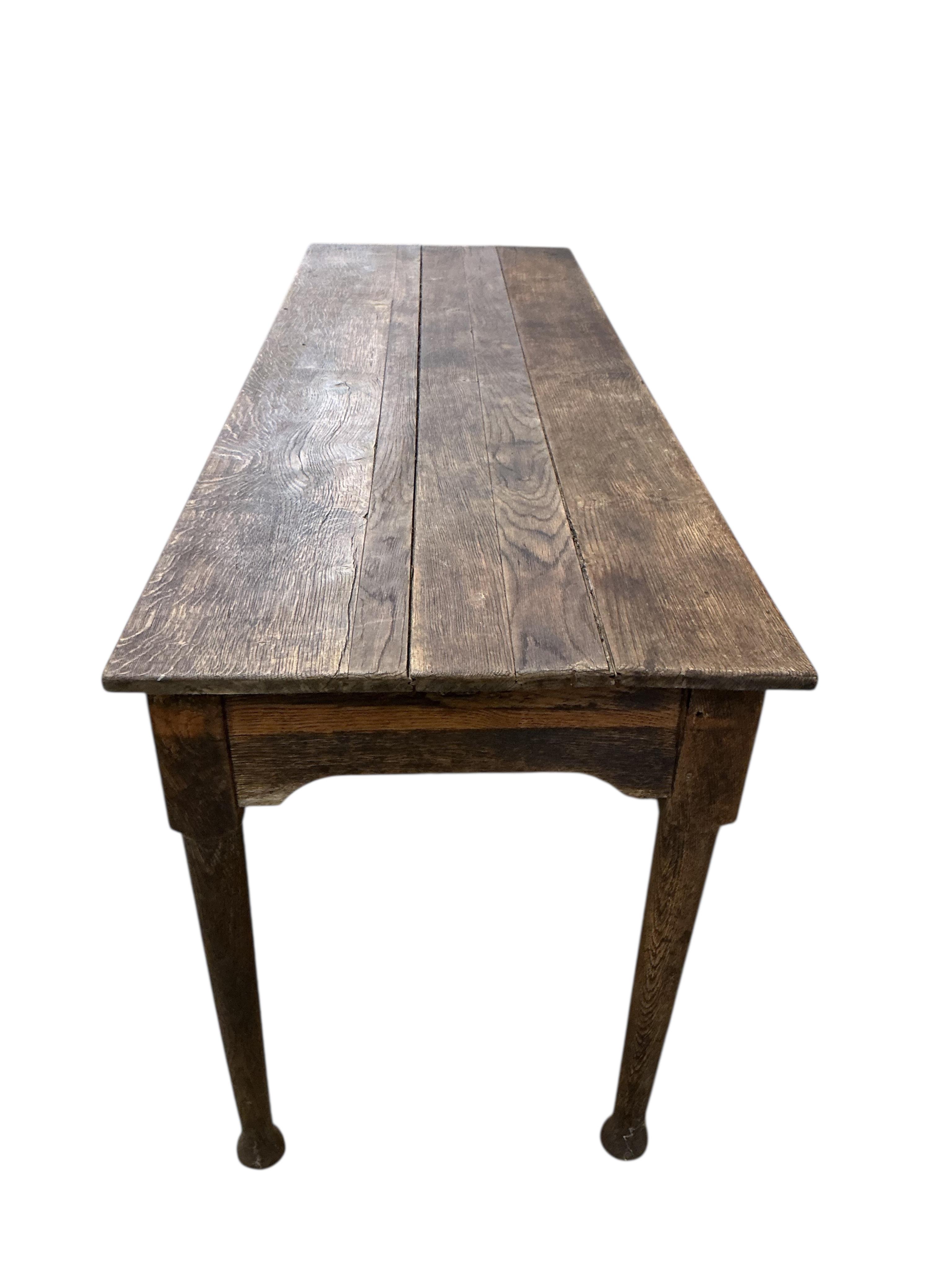A 19th century rectangular oak plank topped dining table, width 183cm, depth 60cm, height 73cm